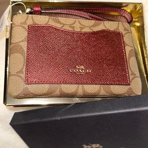 Small coach wristlet. Brand new still in the box.